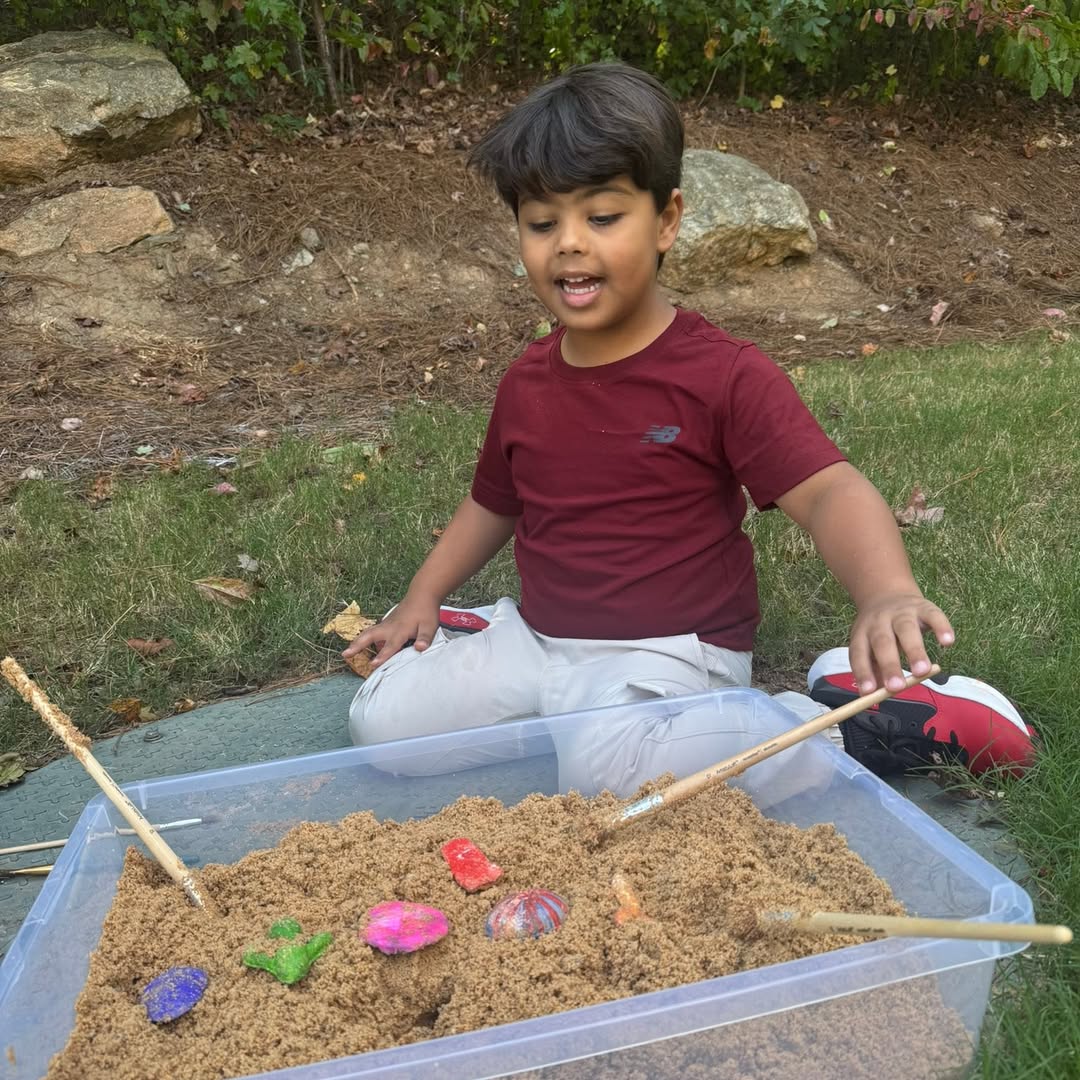 Student digging in a sand bin